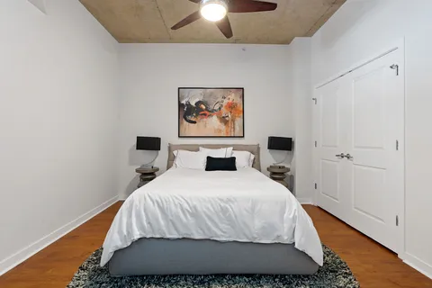 a bedroom with a bed and a chandelier