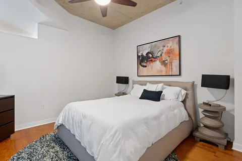 a bedroom with a bed and a lamp