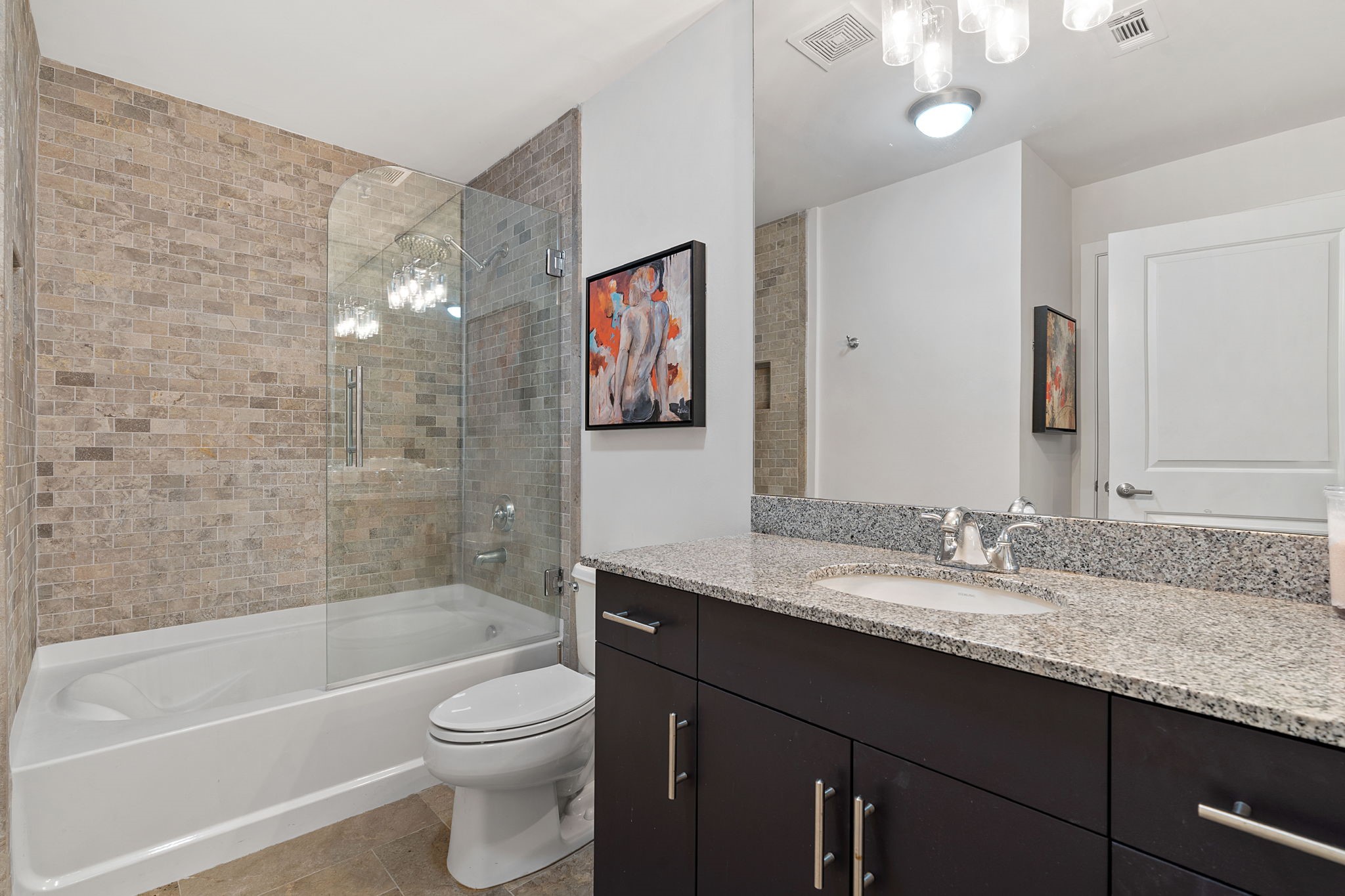 360 Nueces Street, Unit 1310 Austin, TX 78701 - Photo 18 of 40 a bathroom with a granite countertop sink a toilet and bathtub