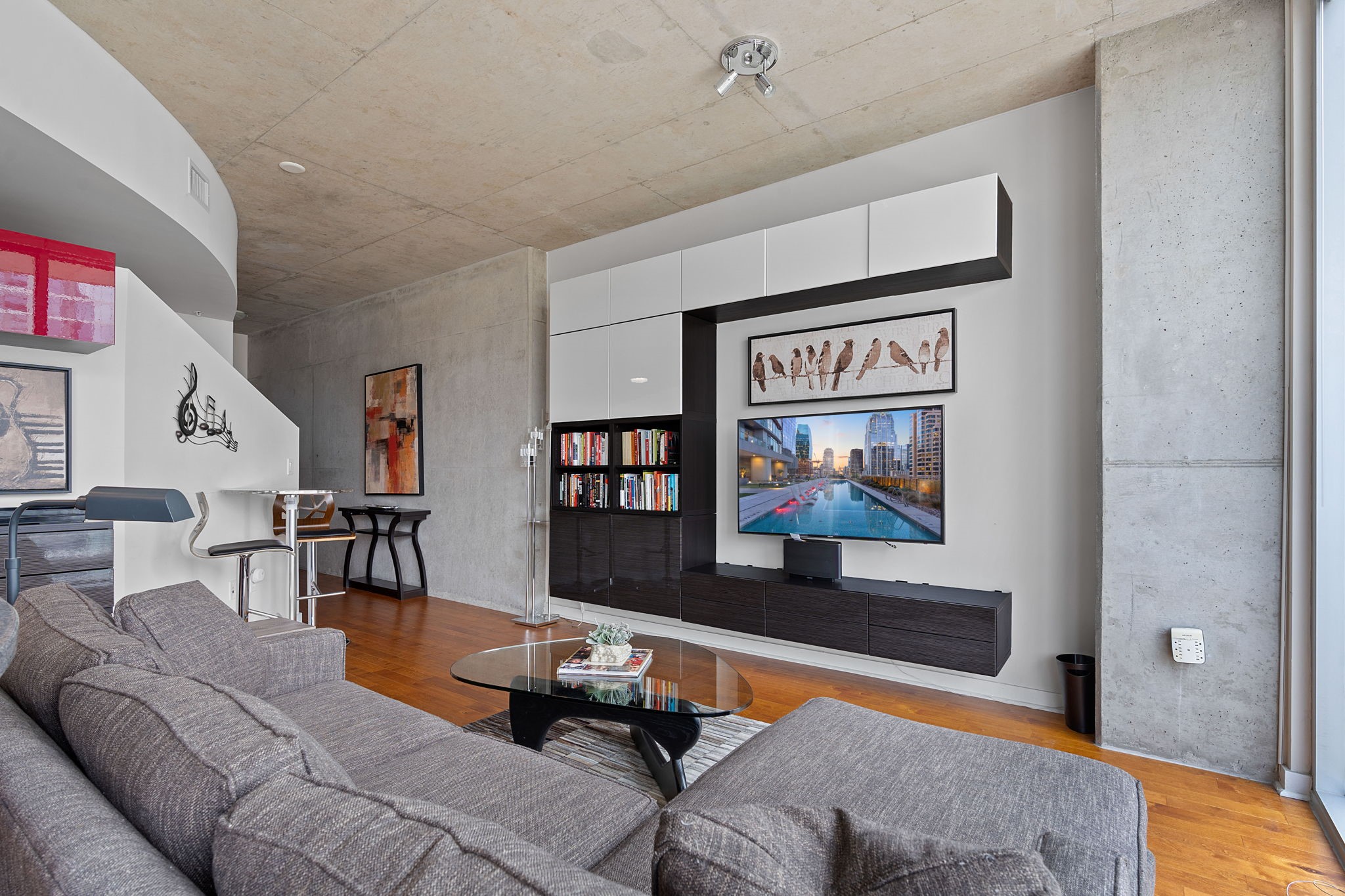 360 Nueces Street, Unit 1310 Austin, TX 78701 - Photo 5 of 40 a living room with furniture and a flat screen tv
