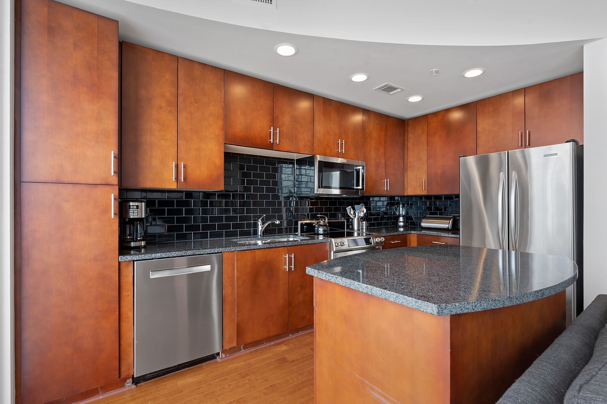 360 Nueces Street, Unit 1310 Austin, TX 78701 - Photo 10 of 40 a kitchen with stainless steel appliances granite countertop a refrigerator a stove and a sink