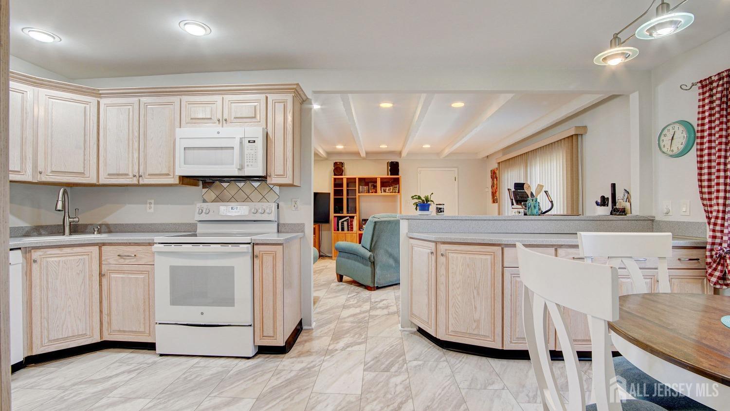 38 Mistletoe Drive Old Bridge, NJ 07747 - Photo 13 of 41 a kitchen with white cabinets and appliances