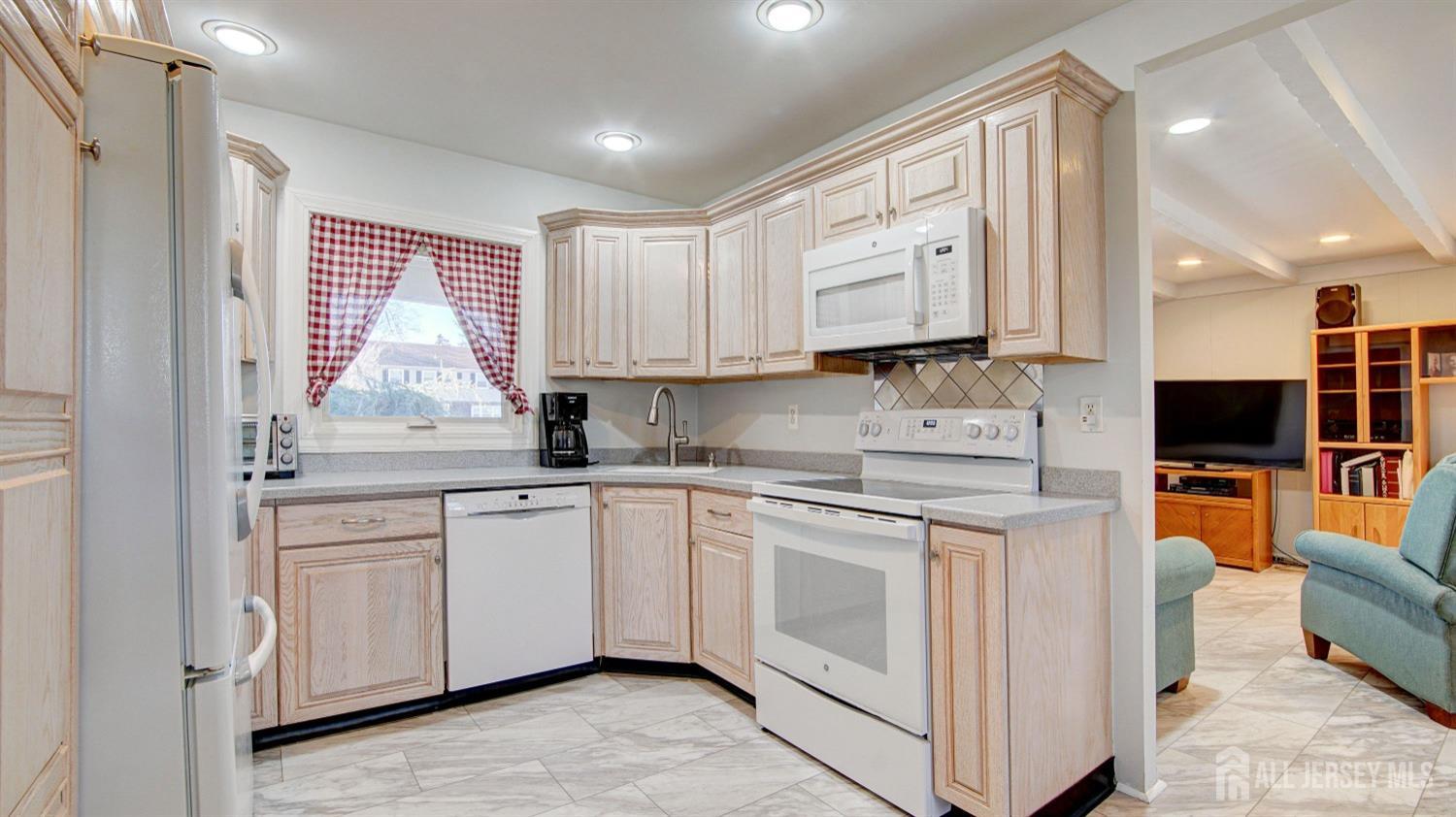 38 Mistletoe Drive Old Bridge, NJ 07747 - Photo 18 of 41 a kitchen with stainless steel appliances granite countertop a stove a sink and a microwave