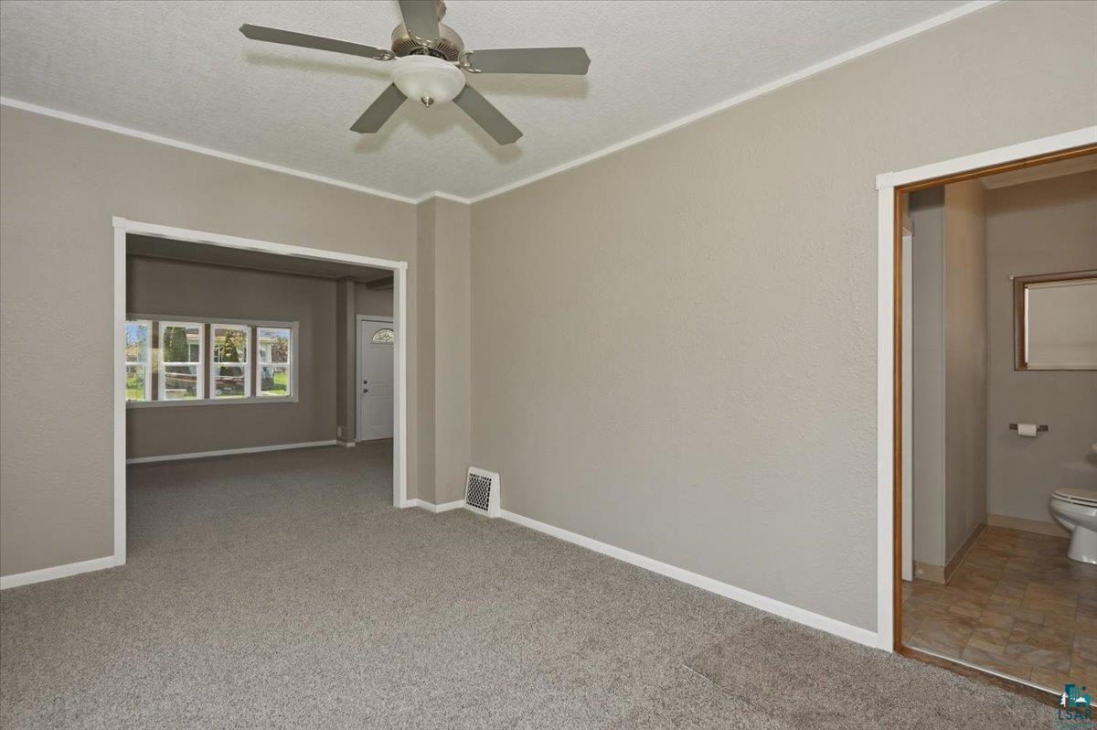 5319 East 3rd Street Superior, WI 54880 - Photo 18 of 33 Carpeted interior space featuring a ceiling fan with light fixture, neutral wall finishes, and white baseboards