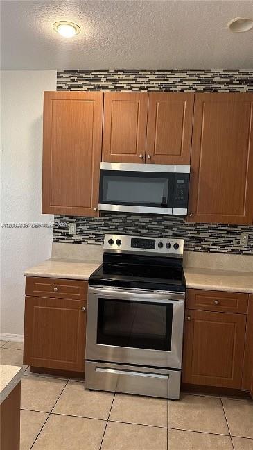 2851 Prospect Road, Unit 1211 Tamarac, FL 33309 - Photo 13 of 15 a stove top oven sitting inside of a kitchen