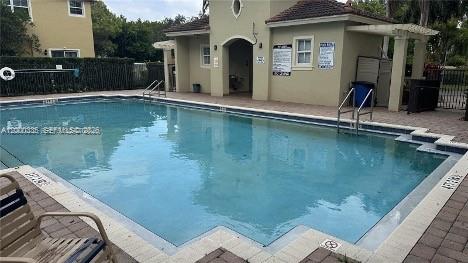 2851 Prospect Road, Unit 1211 Tamarac, FL 33309 - Photo 7 of 15 a front view of a house with swimming pool