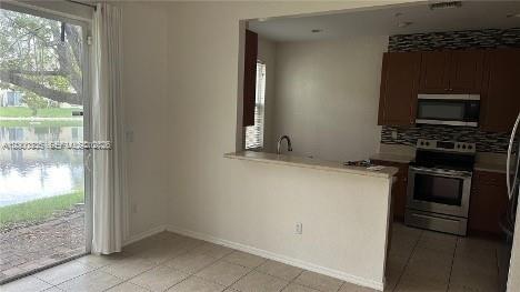 2851 Prospect Road, Unit 1211 Tamarac, FL 33309 - Photo 8 of 15 a kitchen with a stove and a microwave