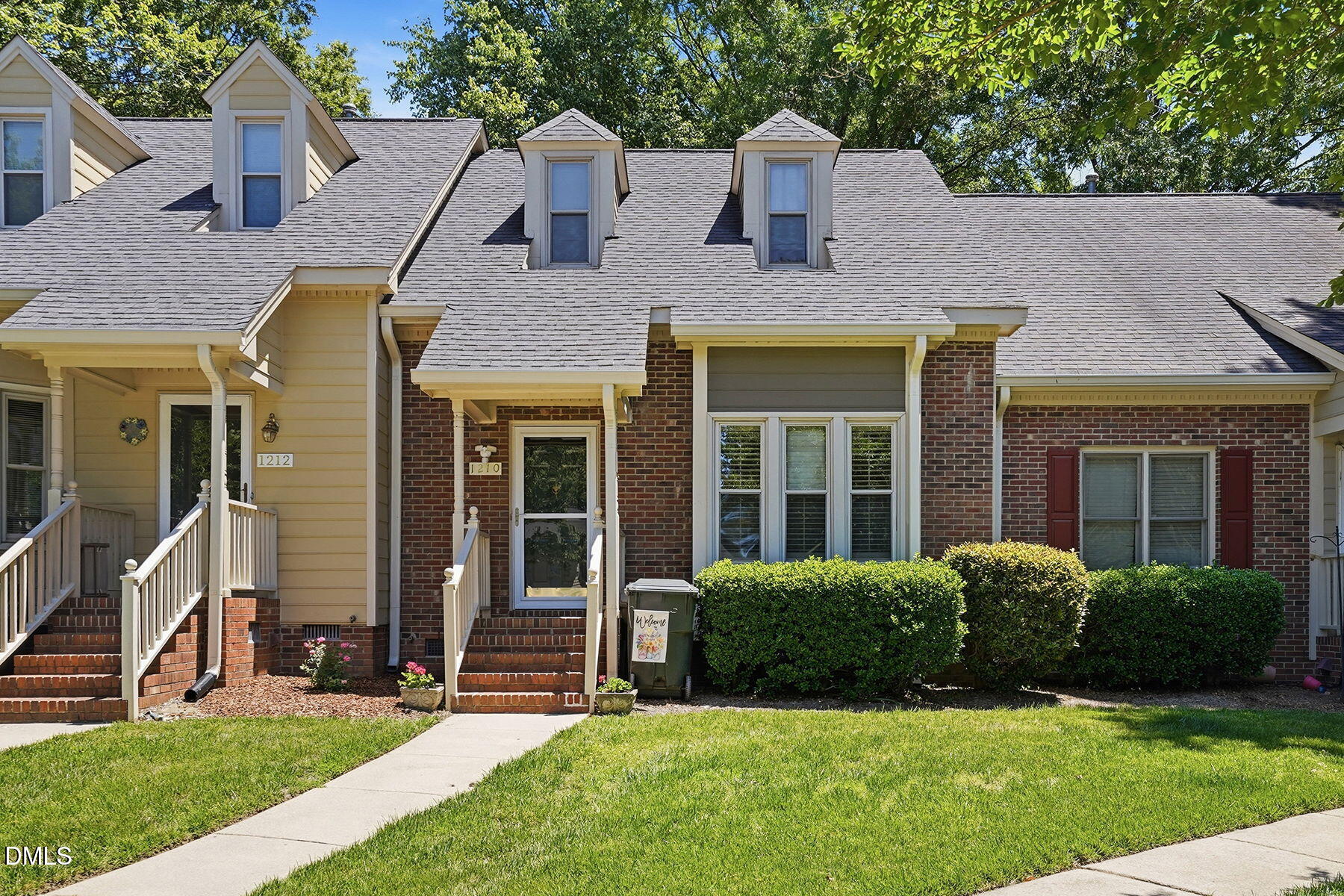 a view of a house with a yard and plants