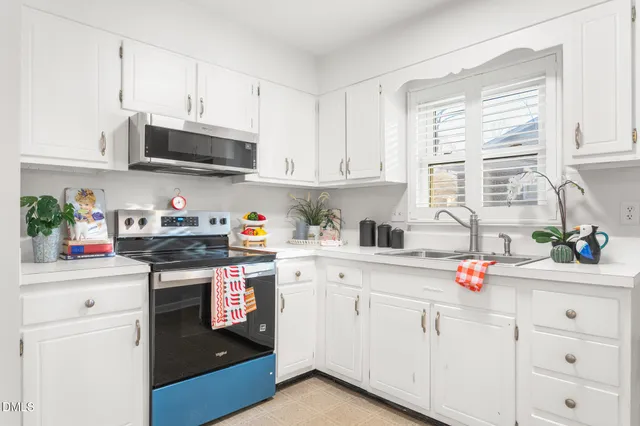 a kitchen with stainless steel appliances granite countertop a sink and cabinets