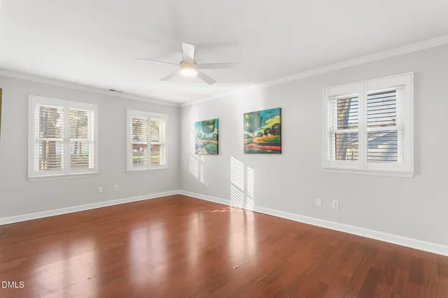 a view of an empty room with wooden floor