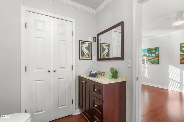 a view of an empty room with wooden floor