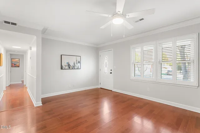 a view of kitchen with cabinets and window