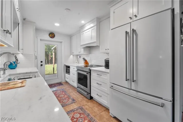 a kitchen with stainless steel appliances granite countertop a sink and a stove