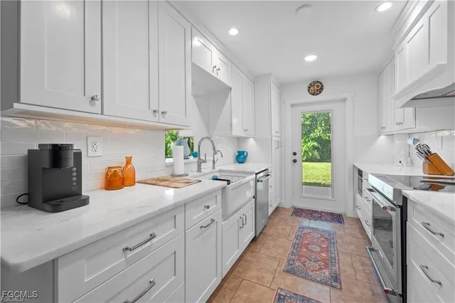 a dining room with furniture a chandelier and window