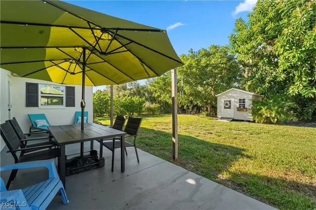 a view of a house with backyard porch and sitting area