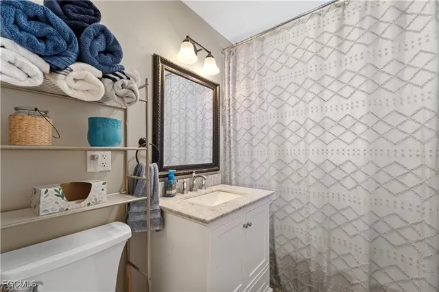 a bedroom with a bed dresser and a flat tv screen