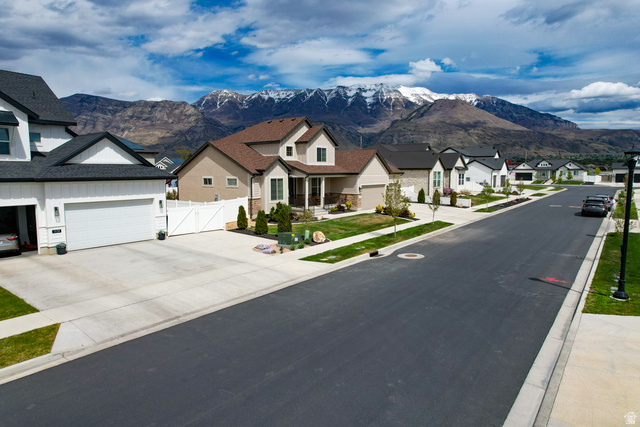 1434 West Stable Street Lindon, UT 84042 - Photo 56 of 76 View of asphalt road with a gate, a residential view, a mountain view, and sidewalks