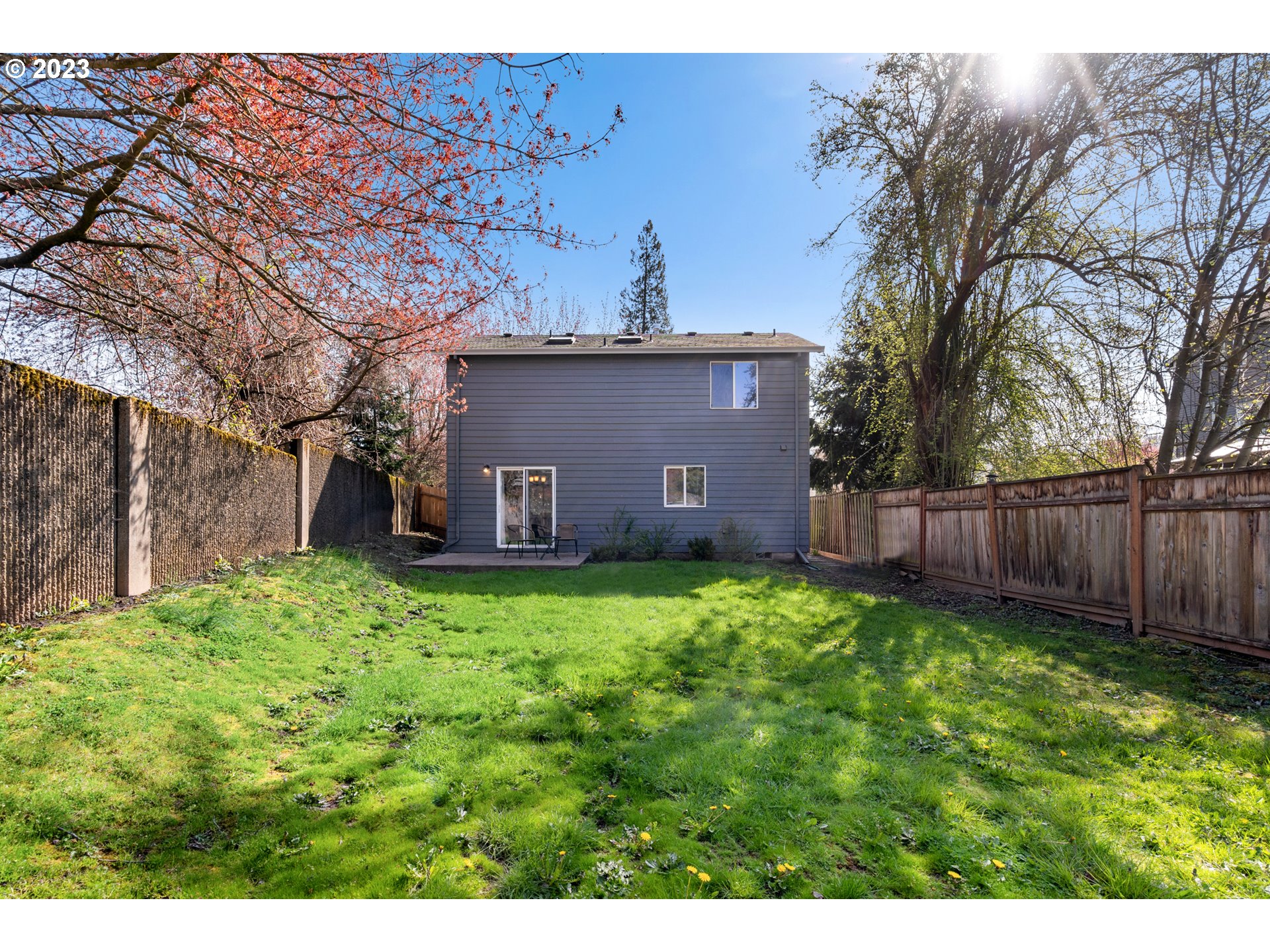 4525 North Colonial Avenue Portland, OR 97217 - Photo 30 of 35 a view of a backyard with potted plants and large trees