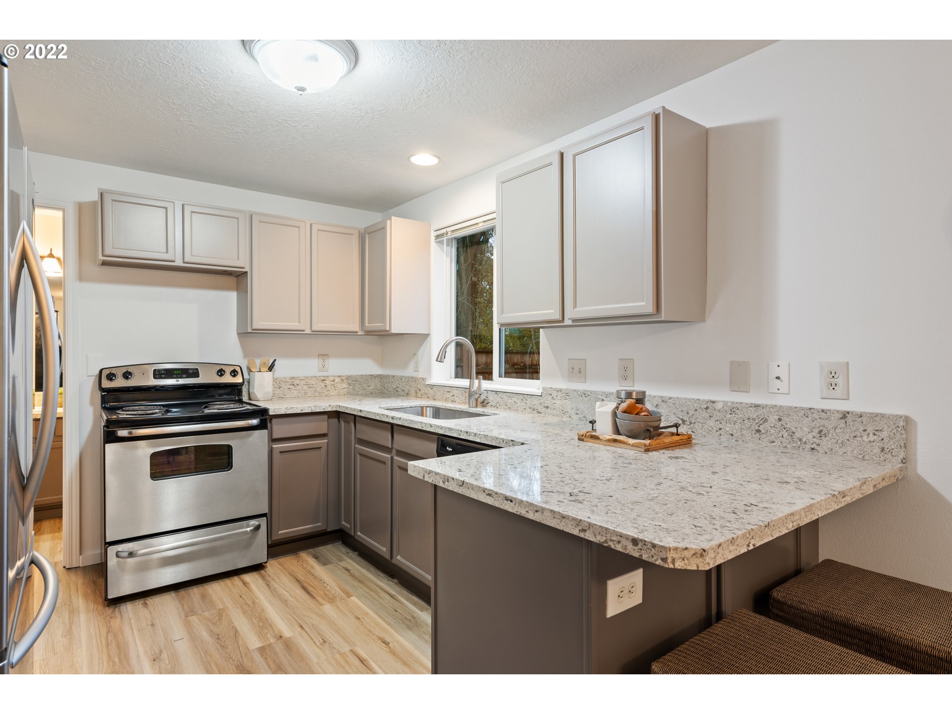 4525 North Colonial Avenue Portland, OR 97217 - Photo 10 of 35 a kitchen with a sink stove and cabinets
