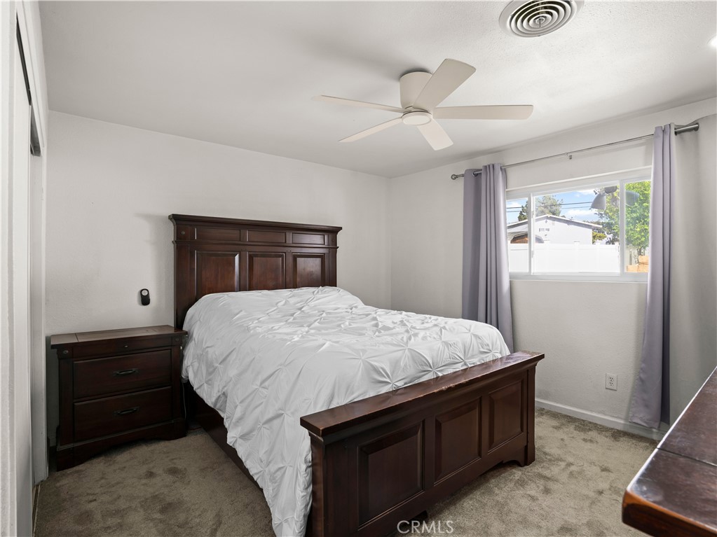 1455 North Alice Avenue Rialto, CA 92376 - Photo 19 of 23 a bedroom with a bed and a window