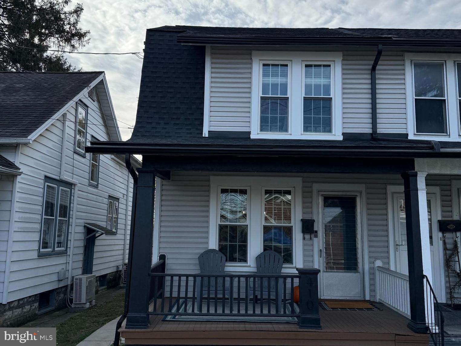 a view of a house with brick walls and wooden fence