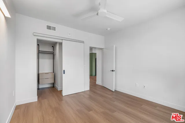 a view of a room with wooden floor and white doors