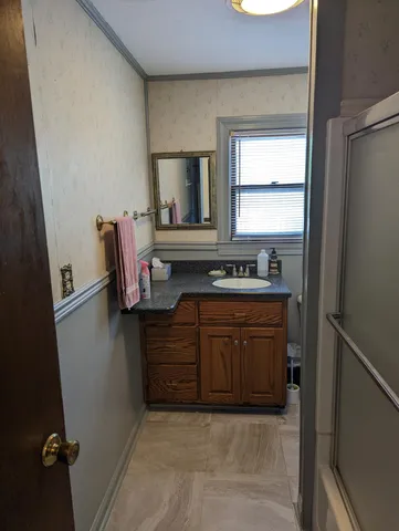 a kitchen with a refrigerator and a stove top oven
