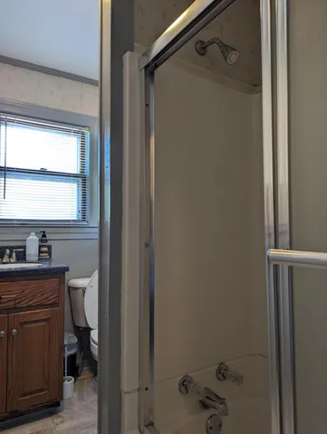 a bathroom with a sink toilet and window