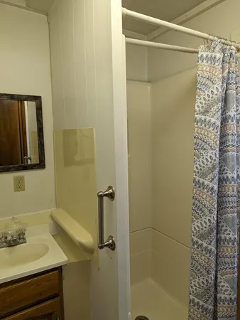 an empty room with windows and ceiling fan