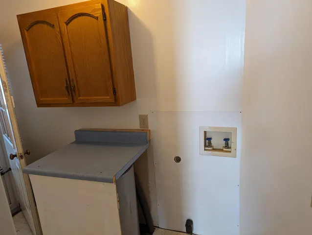 a view of an empty room with a chandelier fan
