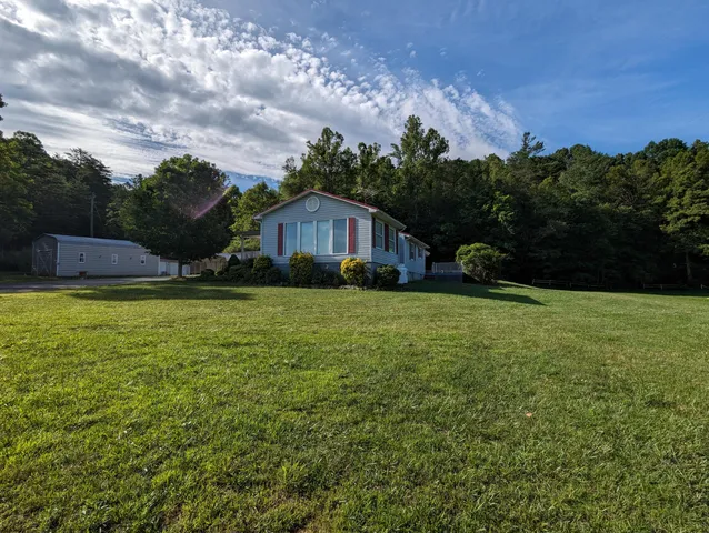 a backyard of a house with lots of green space