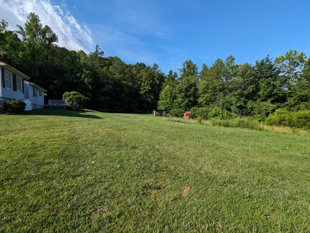 a view of street with houses and trees in the background