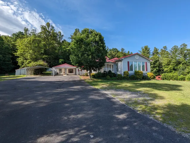 a view of a backyard with sitting area