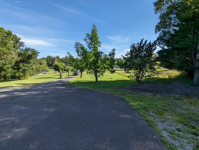 a front view of a house with swimming pool and porch with furniture