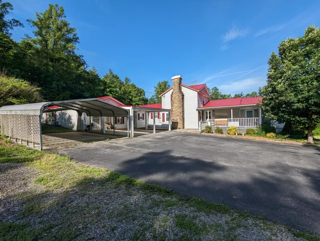 a front view of a house with a yard table and chairs