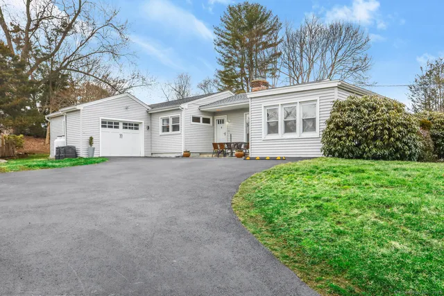 a front view of house with yard and green space