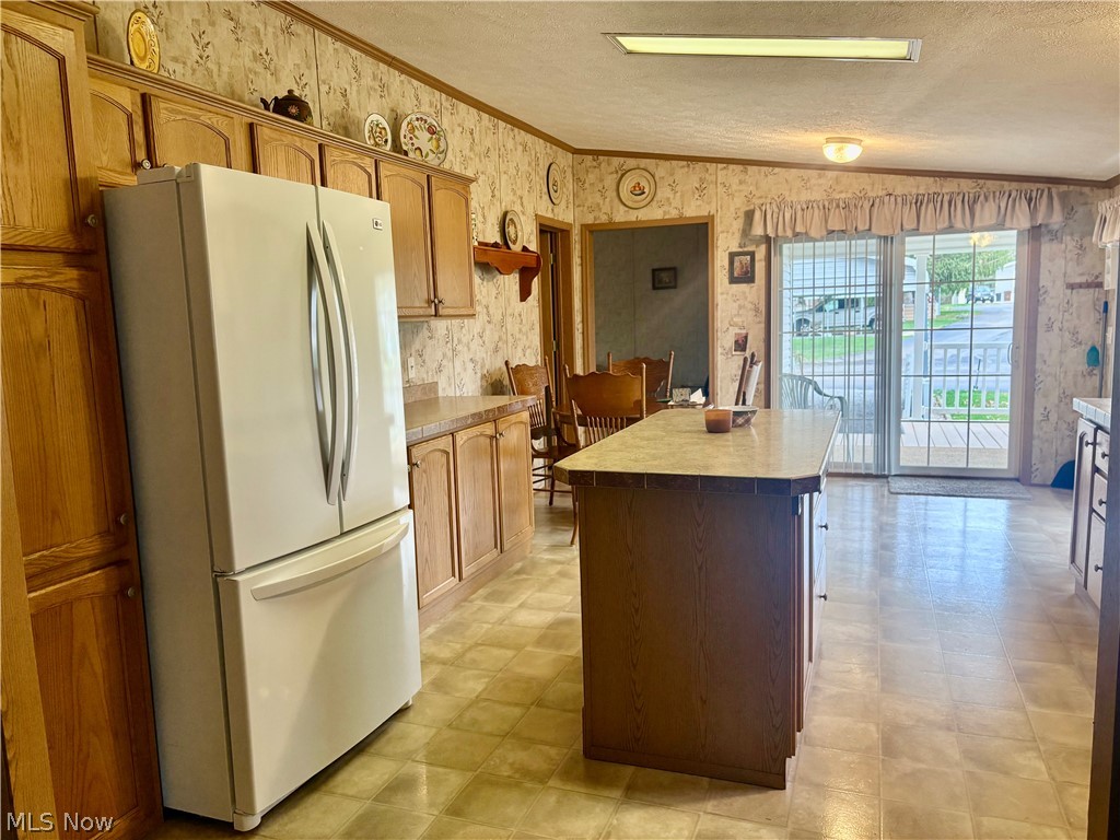 5852 Cleveland Road, Unit 22 Wooster, OH 44691 - Photo 11 of 35 Kitchen island. LVT flooring. Large windows.