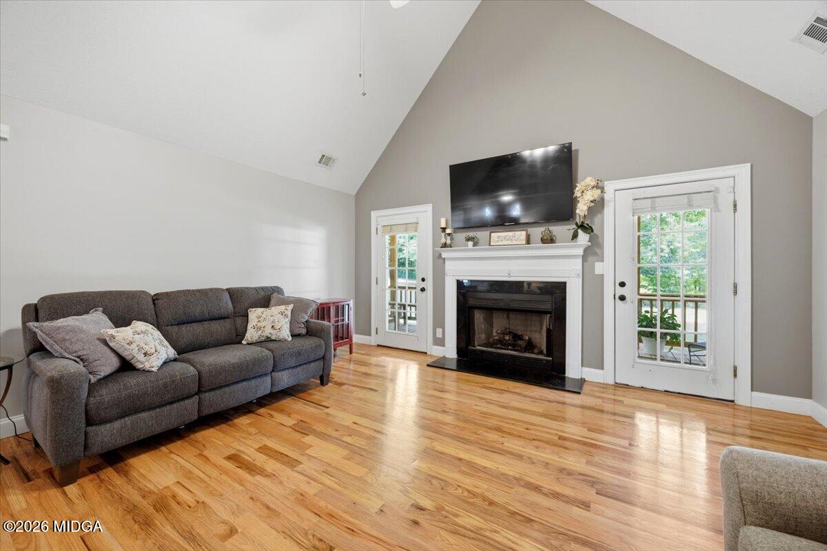 557 Aarons Circle Gray, GA 31032 - Photo 8 of 36 a living room with furniture a flat screen tv and a fireplace