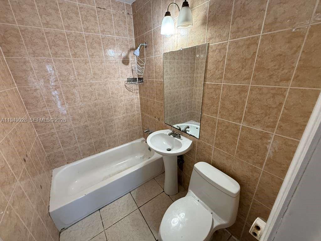 8201 Northwest 5th Court, Unit BACK Miami, FL 33150 - Photo 6 of 9 a bathroom with a sink toilet and shower