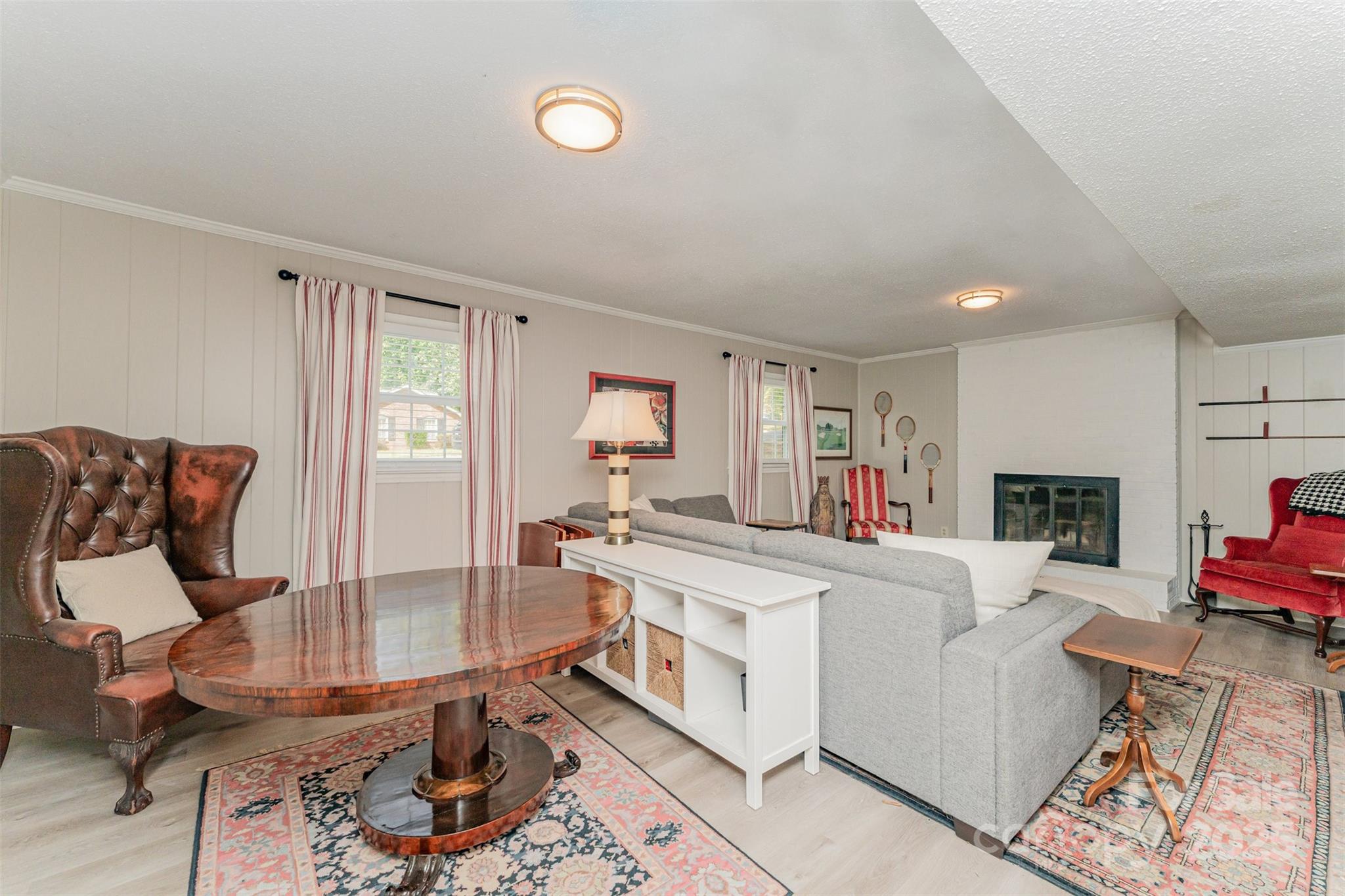 743 Pineborough Road Charlotte, NC 28212 - Photo 18 of 30 a living room with furniture a fireplace and a flat screen tv