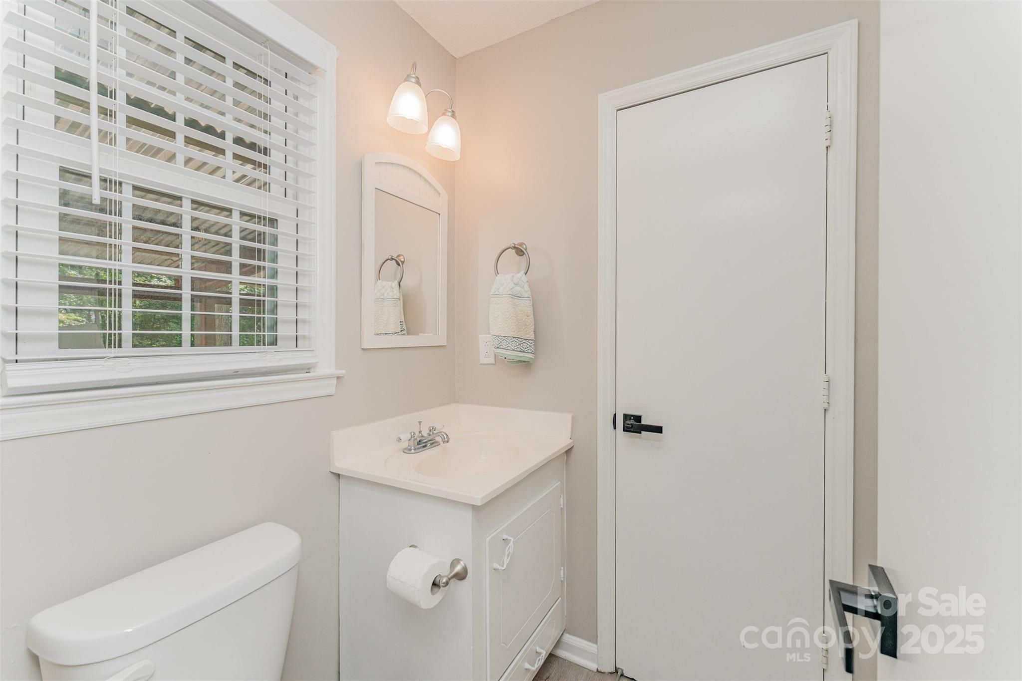 743 Pineborough Road Charlotte, NC 28212 - Photo 22 of 30 a bathroom with a sink a toilet and a window