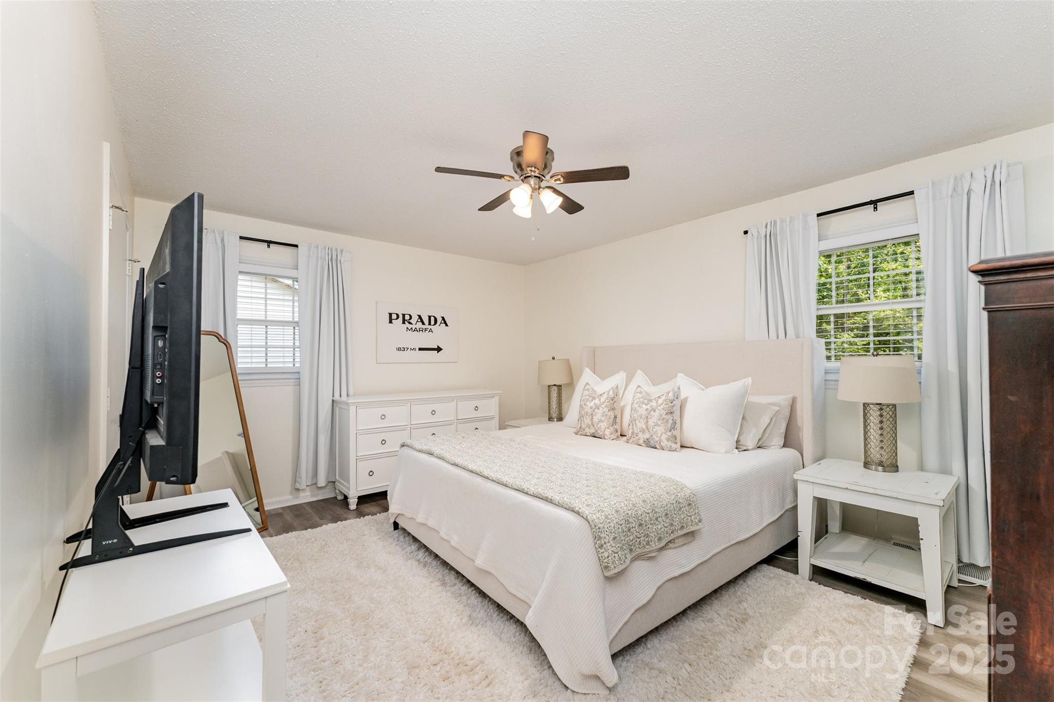 743 Pineborough Road Charlotte, NC 28212 - Photo 9 of 30 a bedroom with a bed and a chandelier