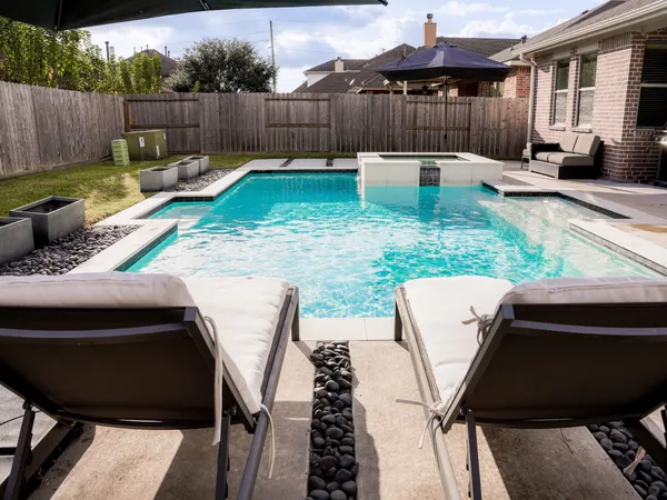 a view of a patio with a table chairs and a yard