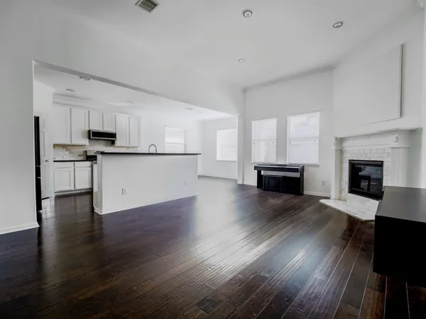 a living room with furniture and kitchen view
