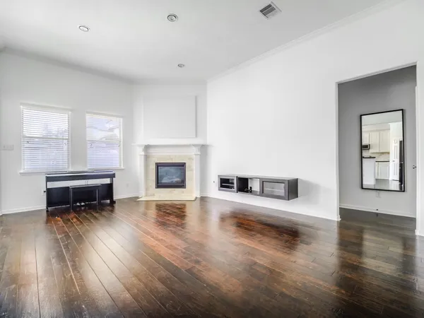 a kitchen with wooden floors and appliances