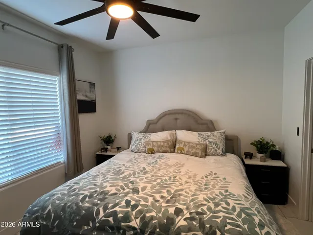 a bedroom with a bed and a chandelier