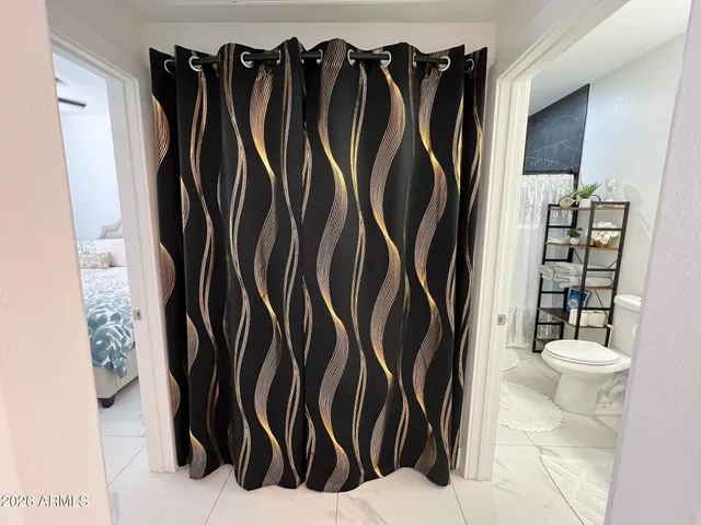 a view of walk in closet with clothes