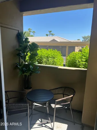 a vase of flowers sitting on a table in front of a window