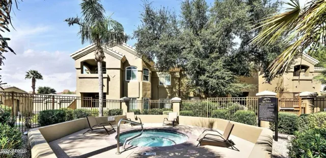 a view of a patio with couches table and chairs and potted plants