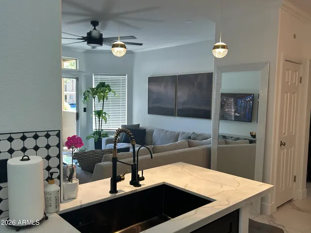 a kitchen with a sink dishwasher and a refrigerator with wooden floor